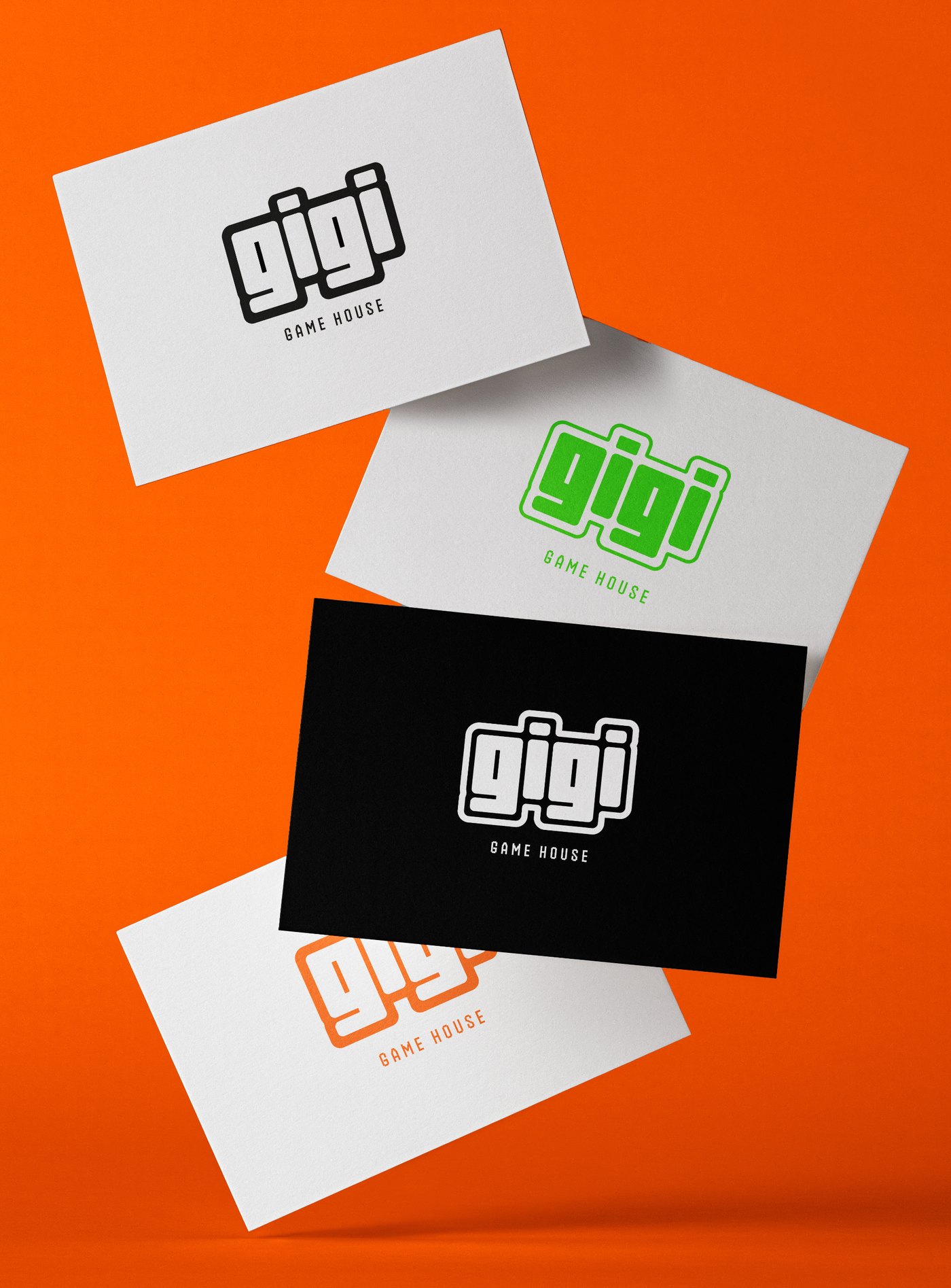 Tarjetas de visita de Gigi Game House en blanco, verde, negro y naranja, suspendidas sobre un fondo naranja.